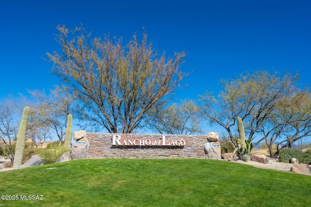 community / neighborhood sign featuring a lawn