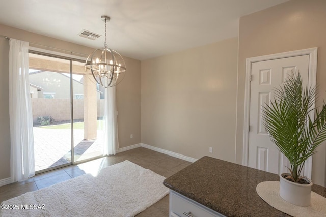 dining space featuring an inviting chandelier and light tile patterned floors