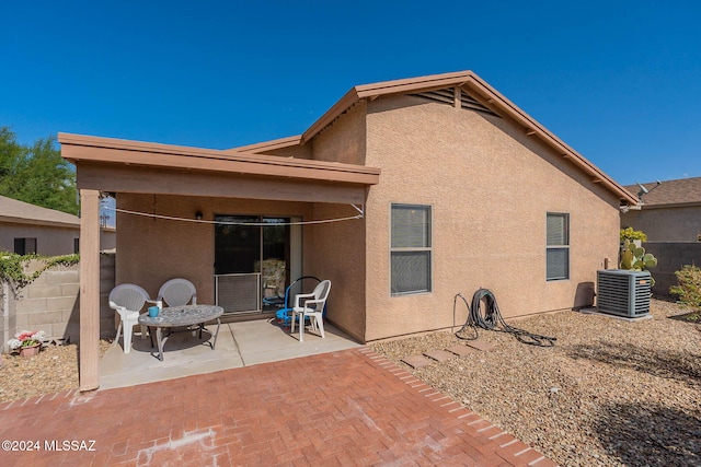 back of property featuring central AC and a patio area