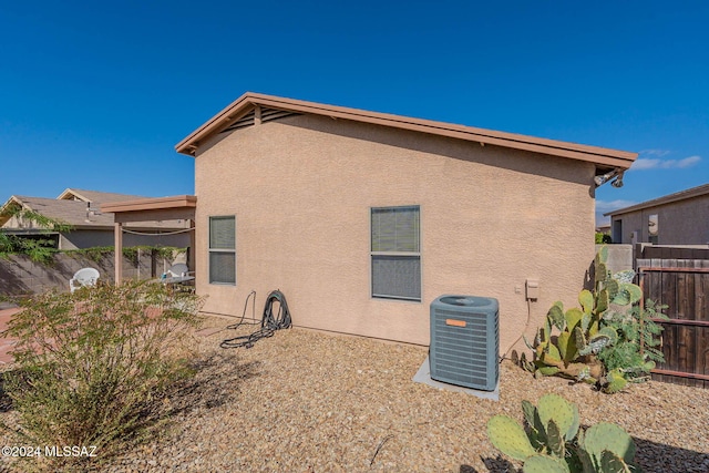 back of house with central air condition unit