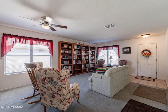 living room featuring light tile patterned floors and ceiling fan