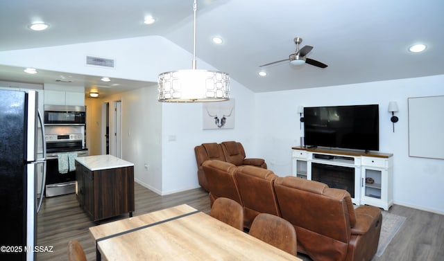 living room featuring vaulted ceiling, ceiling fan, and dark hardwood / wood-style flooring