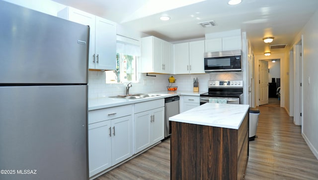 kitchen featuring white cabinetry, appliances with stainless steel finishes, and a kitchen island