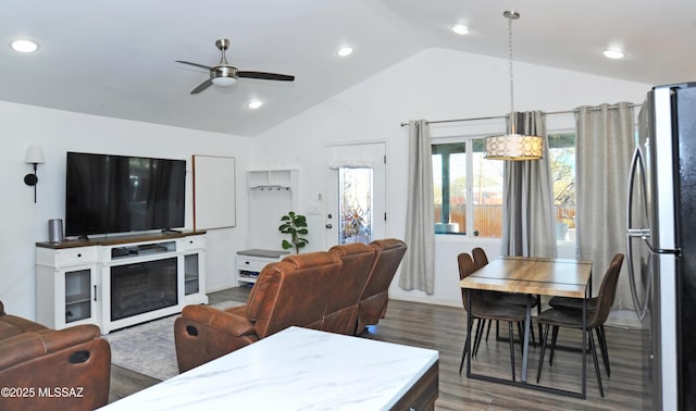 living room featuring vaulted ceiling, ceiling fan, and dark hardwood / wood-style flooring