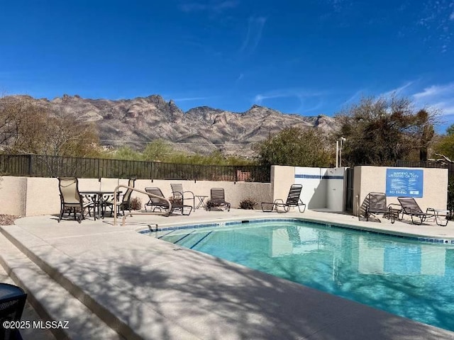 view of pool featuring a mountain view and a patio