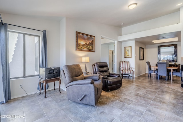 tiled living room featuring lofted ceiling