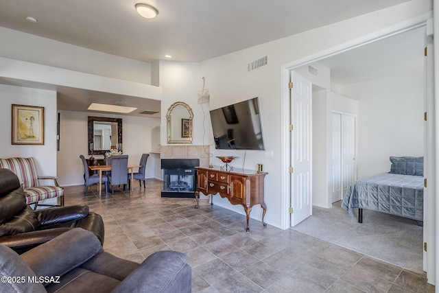 carpeted living room with a fireplace