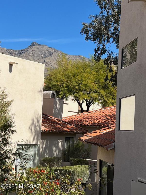 view of side of home with a mountain view