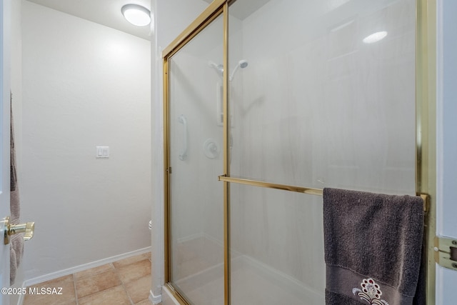 bathroom featuring tile patterned floors and a shower with door