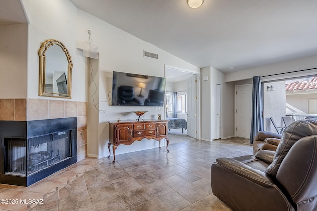 living room with lofted ceiling and a fireplace