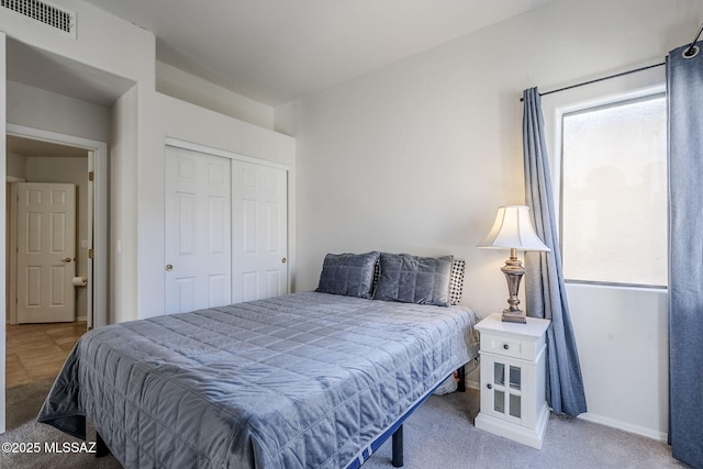 carpeted bedroom with a closet