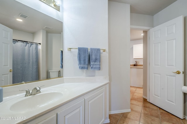 bathroom featuring tile patterned floors, toilet, and vanity