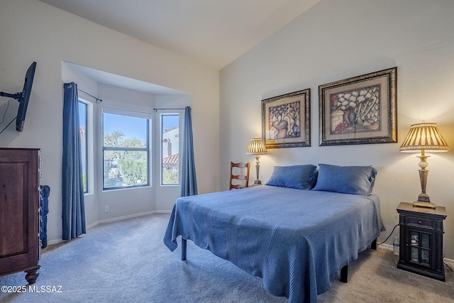 carpeted bedroom with vaulted ceiling