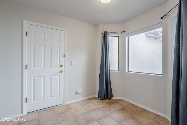 unfurnished room featuring light tile patterned floors