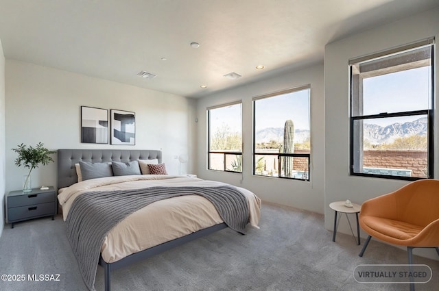 carpeted bedroom with visible vents, a mountain view, and recessed lighting