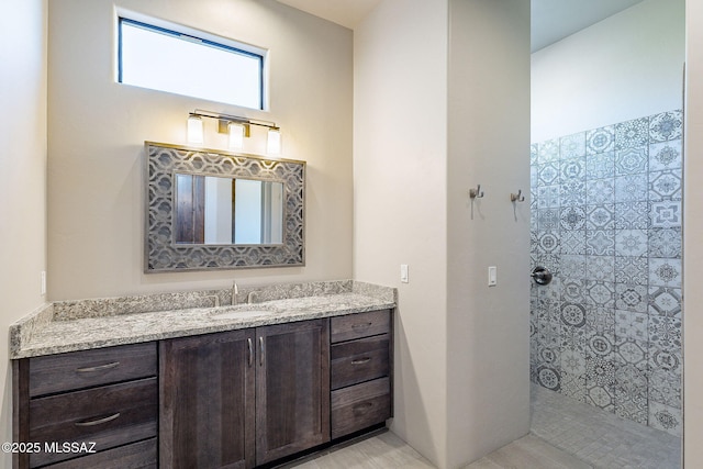 full bathroom featuring walk in shower and vanity