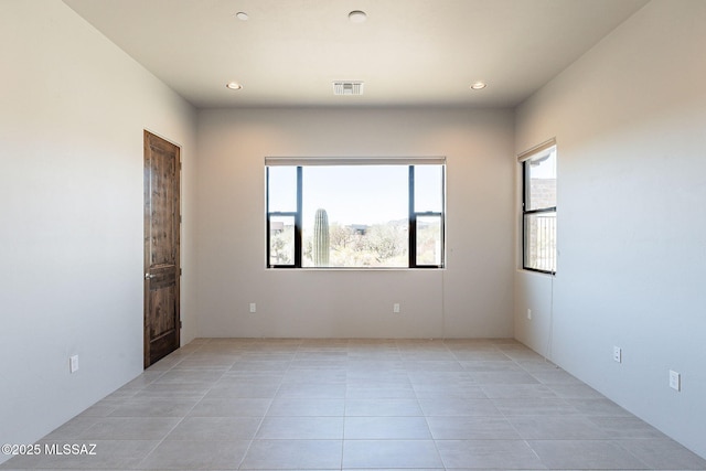 spare room featuring recessed lighting, visible vents, and light tile patterned floors