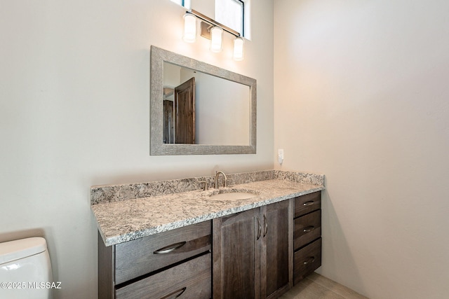 half bathroom with vanity and toilet