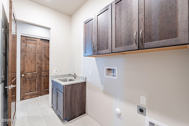 laundry room featuring light tile patterned flooring, hookup for a washing machine, hookup for an electric dryer, a sink, and cabinet space