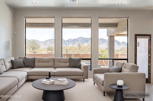 living room featuring visible vents, a mountain view, and recessed lighting