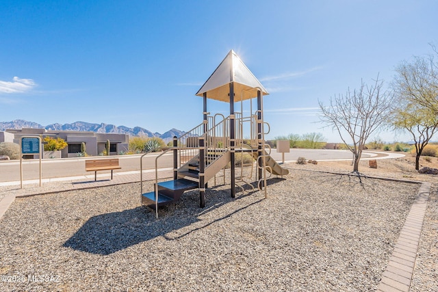 community jungle gym with a mountain view