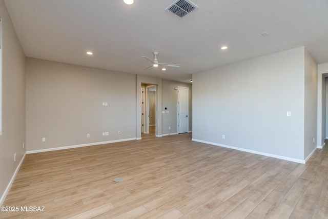 spare room with ceiling fan and light wood-type flooring