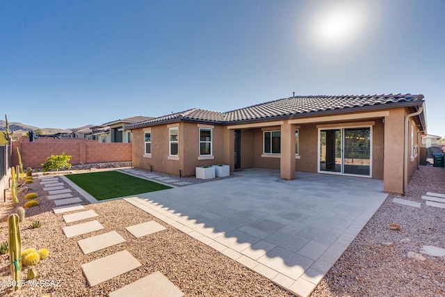 rear view of property featuring a patio area