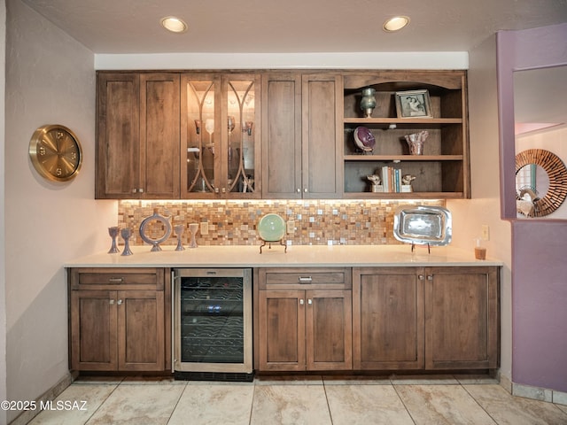 bar with a dry bar, recessed lighting, backsplash, beverage cooler, and baseboards