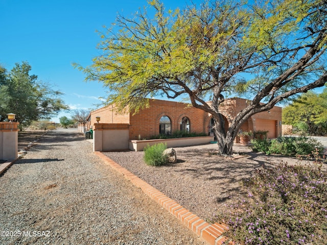 view of front of house featuring a garage and brick siding