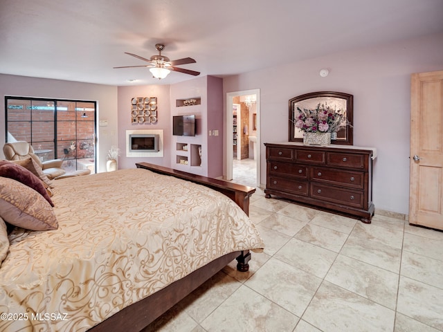 bedroom featuring light tile patterned floors, a fireplace, and a ceiling fan