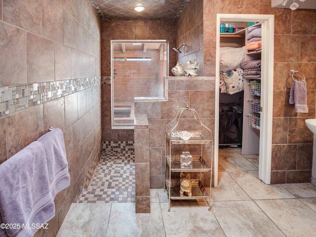 full bath featuring tile walls and tiled shower