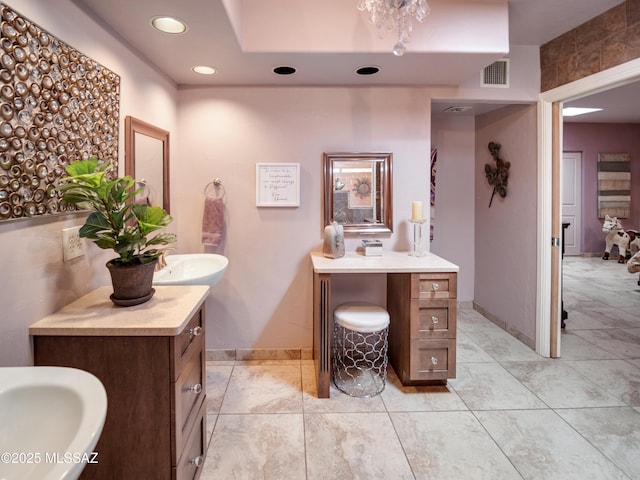 bathroom featuring two vanities, a sink, visible vents, and recessed lighting