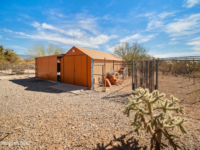 view of outbuilding featuring an outdoor structure and fence