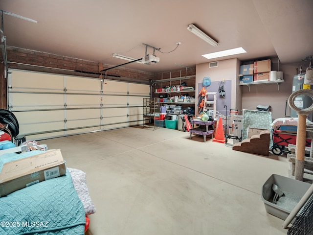 garage featuring a garage door opener and visible vents