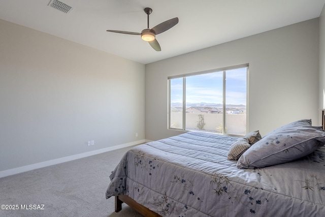 bedroom featuring ceiling fan, carpet flooring, and a mountain view