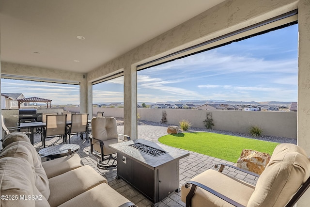 view of patio / terrace with an outdoor living space with a fire pit