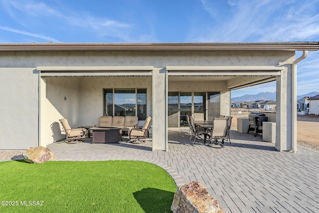 rear view of property featuring outdoor lounge area and a patio