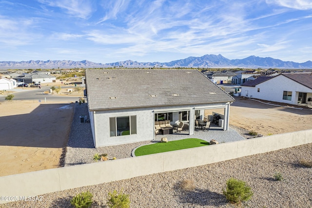 rear view of house featuring a mountain view and a patio area