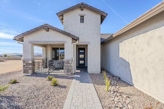 view of exterior entry featuring a patio