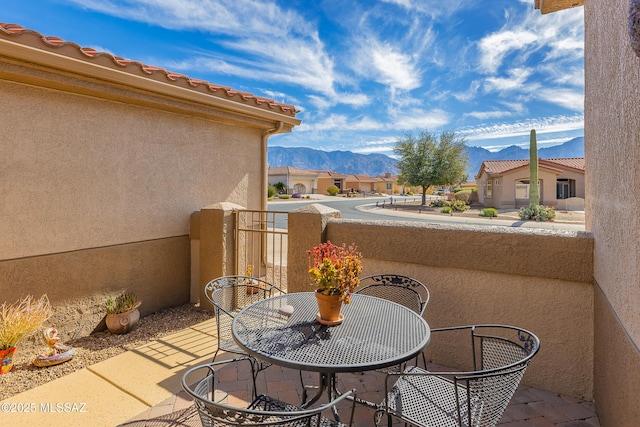 balcony with a residential view and a mountain view