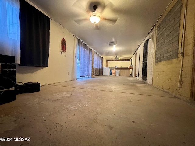 miscellaneous room featuring ceiling fan and concrete floors