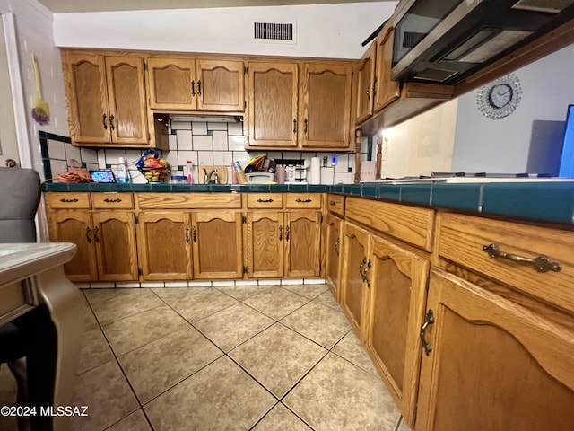 kitchen featuring light tile patterned floors and tile counters