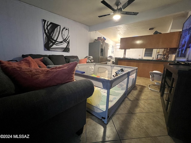 tiled living room featuring ceiling fan