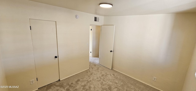 unfurnished bedroom with light colored carpet