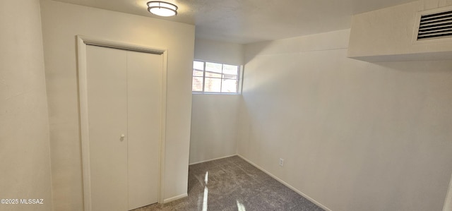 unfurnished bedroom featuring carpet flooring and a closet