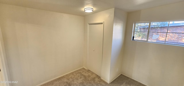 interior space with light carpet and a closet