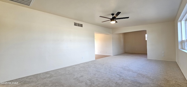 carpeted spare room with ceiling fan