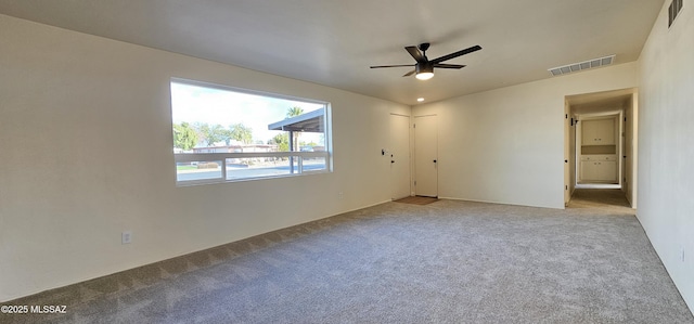 empty room featuring light colored carpet and ceiling fan