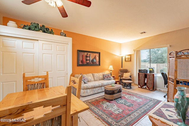 tiled living room featuring ceiling fan