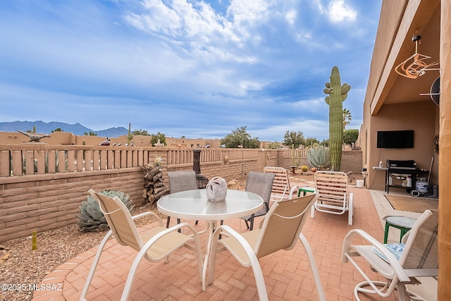 view of patio / terrace featuring a mountain view